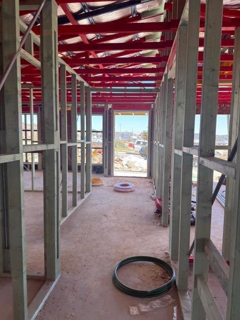 Load-bearing stud over-notched for electrical conduit — 55% cross-section reduction — sister stud required.