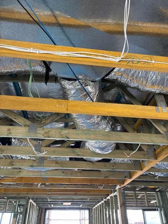Timber structural post misaligned — out of plumb breach of NCC tolerances — builder rectification required.